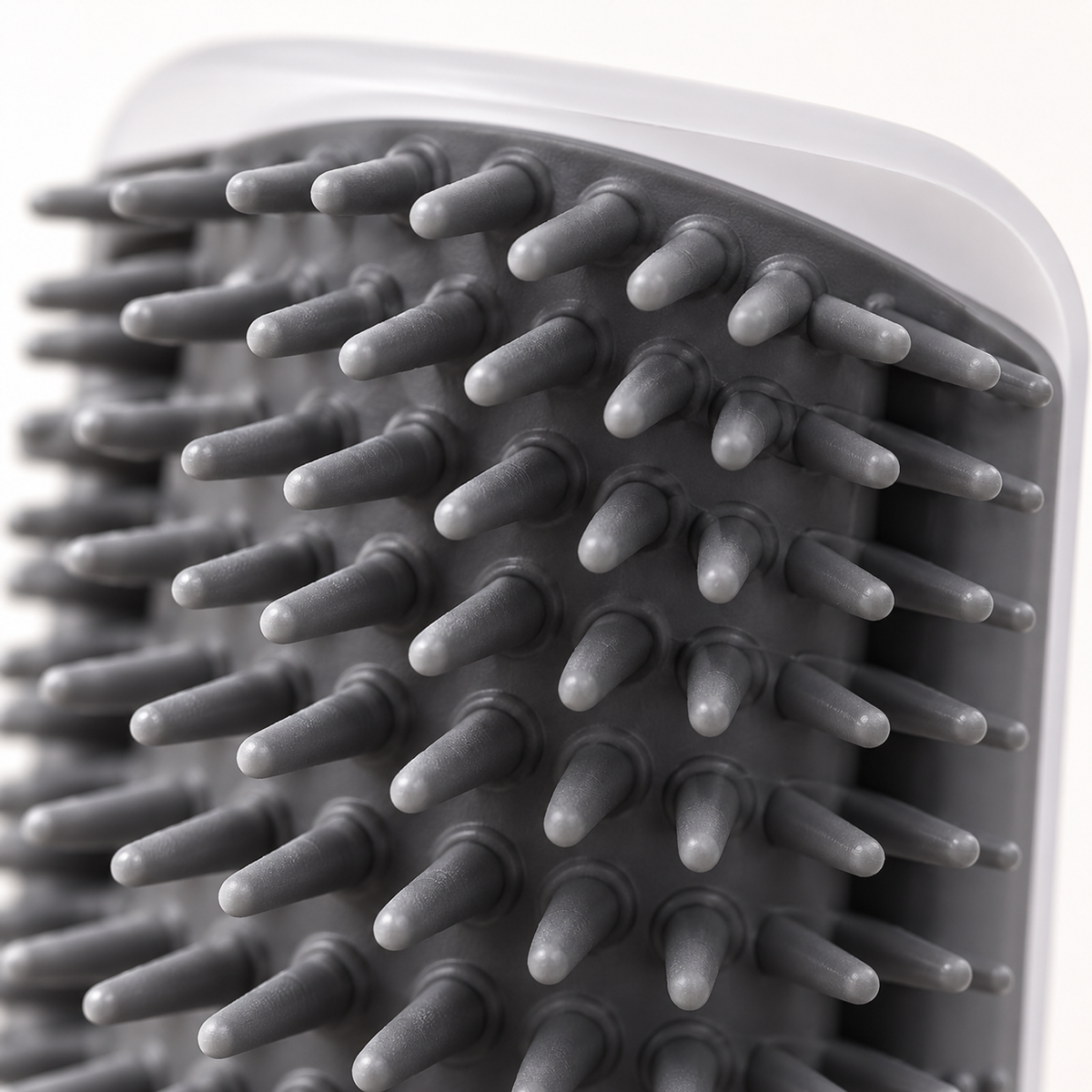Close-up of the soft TPR bristles and vented back of the Mewnook corner groomer