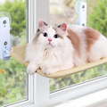 Mewnook window hammock in beige mesh fitted to a window with two suction brackets and a cat resting on it